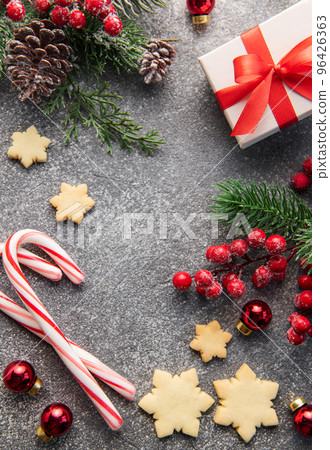 Christmas background with gingerbread cookies, gift boxe and fir branches on darck concrete background. Christmas background with gingerbread cookies, gift boxe and fir branches on darck concrete background. 96426363