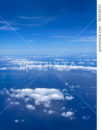 Aerial view of clouds and blue sky over ocean, cloudscape top view from airplane. Aerial view of clouds and blue sky over ocean, cloudscape top view from airplane. 96428433