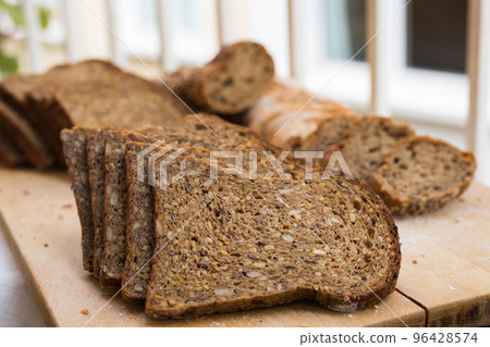 fresh loaf of bread on wooden board 96428574