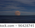 Photo of the moon rising over the sea 96428745