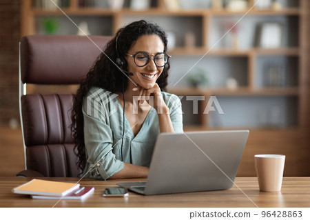 Cheerful brunette businesswoman having video conference with patrners 96428863