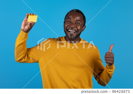 Happy african american mature man recommending credit card Happy african american mature man recommending credit card 96428873