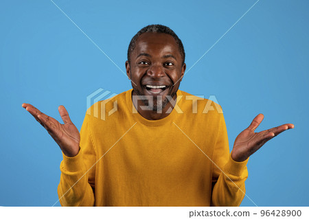 Surprised african american man gesturing on blue studio background Surprised african american man gesturing on blue studio background 96428900
