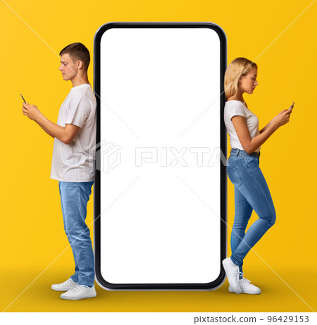 Online Communication. Millennial Man And Woman Leaning On Huge Black Smartphone Online Communication. Millennial Man And Woman Leaning On Huge Black Smartphone 96429153