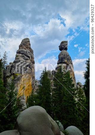Beautiful rocks in the forest against the blue sky. Beautiful rocks in the forest against the blue sky. 96429327