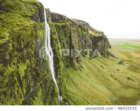 Moss coverd rocks and waterfall falling over them - Iceland Moss coverd rocks and waterfall falling over them - Iceland 96429539