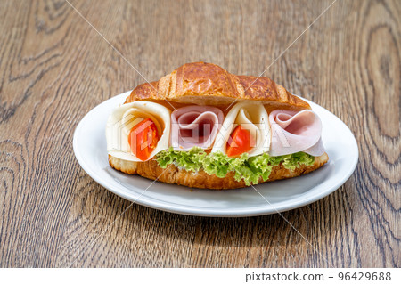 Croissant filled with ham, cheese and vegetables 96429688