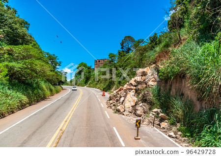 asphalt road damaged by a landslide in a mountain area 96429728