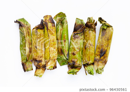 Grilled sticky rice in banana leaves with banana filling Grilled sticky rice in banana leaves with banana filling 96430561