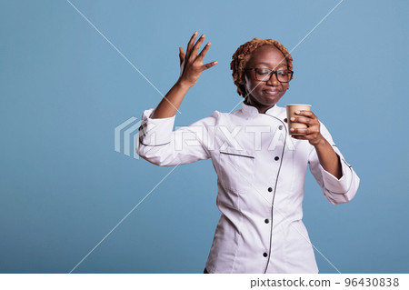 Kitchen employee enjoying cup of coffee on break. Professional african american cooker savoring freshly brewed coffee. Afro young girl uniformed enjoying taste of coffee. Kitchen employee enjoying cup of coffee on break. Professional african american cooker savoring freshly brewed coffee. Afro young girl uniformed enjoying taste of coffee. 96430838