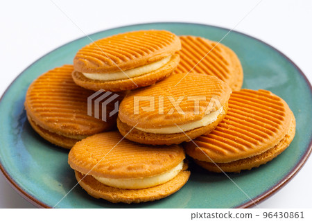 Custard cream sandwich biscuits on white background. 96430861