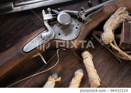 17th century ancient flintlock musket with powder flask and led bullets. 17th century ancient flintlock musket with powder flask and led bullets. 96432324