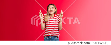 Hopeful dreamy tender blond asian cute girl close eyes smiling cheerful believe dream come true, cross fingers good luck, make wish, anticipate good fortune results, stand red background have faith Hopeful dreamy tender blond asian cute girl close eyes smiling cheerful believe dream come true, cross fingers good luck, make wish, anticipate good fortune results, stand red background have faith 96432610