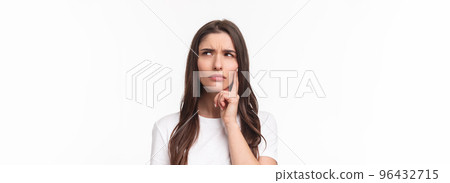 Close-up portrait of serious-looking woman processing situation in mind, looking up frowning doubtful, having hesitating feeling, thinking touching face, standing white background pondering 96432715