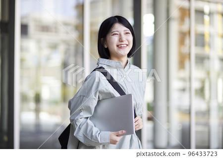 Young Japanese college student enjoying campus life 96433723