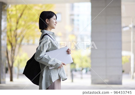 Young Japanese college student enjoying campus life 96433745