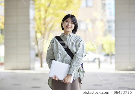 Young Japanese college student enjoying campus life 96433750