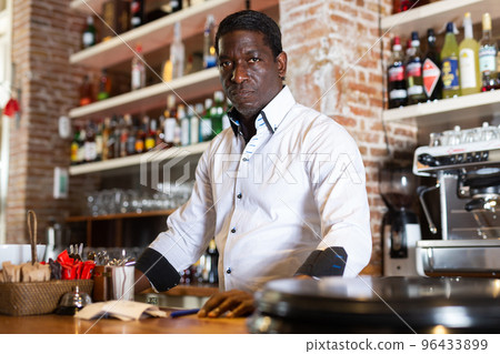 Professional bartender prepares cocktail for restaurant guests Professional bartender prepares cocktail for restaurant guests 96433899