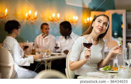 Woman at dinner at the restaurant 96434035