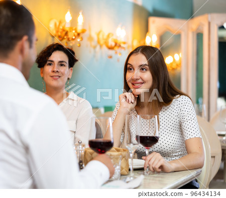 Group of satisfied friends enjoying evening meal at restaurant Group of satisfied friends enjoying evening meal at restaurant 96434134