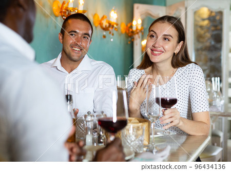 Group of satisfied friends enjoying evening meal at restaurant Group of satisfied friends enjoying evening meal at restaurant 96434136