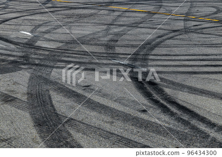 Tire track mark on asphalt tarmac road race track texture and background, Abstract background black tire tracks skid on asphalt road in racing circuit, Tire mark skid mark on asphalt road. Tire track mark on asphalt tarmac road race track texture and background, Abstract background black tire tracks skid on asphalt road in racing circuit, Tire mark skid mark on asphalt road. 96434300