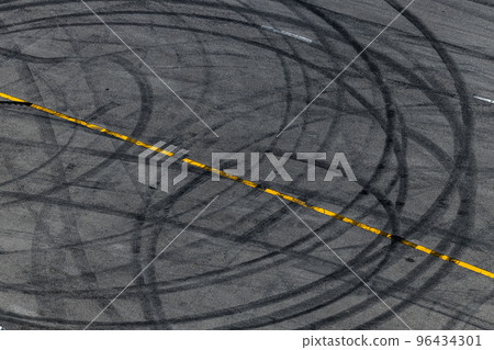 Tire track mark on asphalt tarmac road race track texture and background, Abstract background black tire tracks skid on asphalt road in racing circuit, Tire mark skid mark on asphalt road. Tire track mark on asphalt tarmac road race track texture and background, Abstract background black tire tracks skid on asphalt road in racing circuit, Tire mark skid mark on asphalt road. 96434301