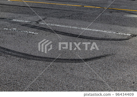 Tire track mark on asphalt tarmac road race track texture and background, Abstract background black tire tracks skid on asphalt road in racing circuit, Tire mark skid mark on asphalt road. Tire track mark on asphalt tarmac road race track texture and background, Abstract background black tire tracks skid on asphalt road in racing circuit, Tire mark skid mark on asphalt road. 96434409