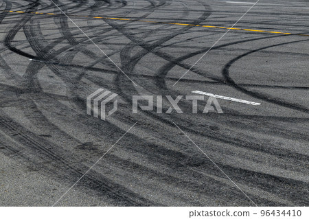 Tire track mark on asphalt tarmac road race track texture and background, Abstract background black tire tracks skid on asphalt road in racing circuit, Tire mark skid mark on asphalt road. 96434410