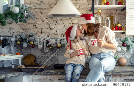 family in the kitchen decorating for Christmas 96439121