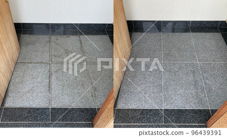 Before and after cleaning on an old gray granite entryway floor 96439391