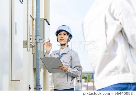 Engineer inspecting equipment 96440098