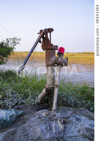Traditional Tube well in the village. Tube wells are used to pump out water from the ground Traditional Tube well in the village. Tube wells are used to pump out water from the ground 96443364