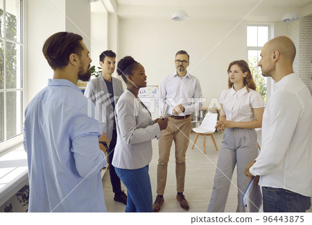 Group of young scientists from different countries communicate during break in scientific symposium with a supervisor. Group of young scientists from different countries communicate during break in scientific symposium with a supervisor. 96443875