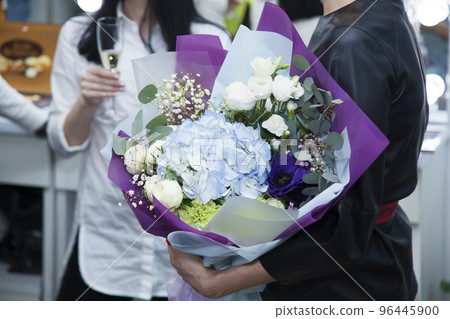Girl holding a bouquet of flowers 96445900