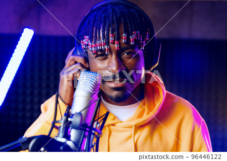 Young African performer recording his new track in recording studio Young African performer recording his new track in recording studio 96446122