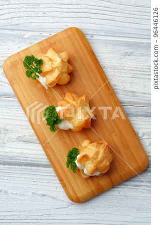 Profiteroles stuffed with soft mousse banquet food snacks 96446126