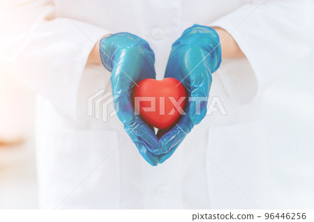 close up. doctor in protective gloves holds the heart . close up. doctor in protective gloves holds the heart . 96446256