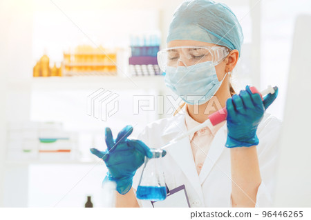 female laboratory assistant conducts blood tests in the laboratory female laboratory assistant conducts blood tests in the laboratory 96446265