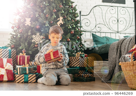 Cute little boy holding a gift box for Christmas 96446269