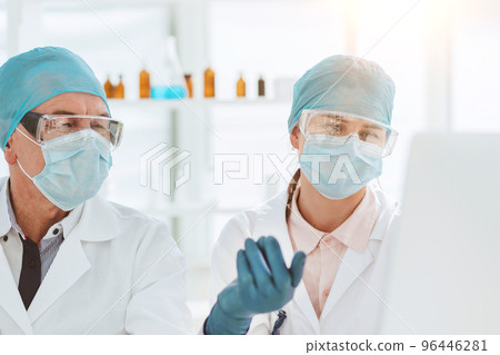group of scientists using a computer to classify data. group of scientists using a computer to classify data. 96446281