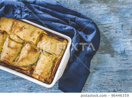 baked stuffed crepes on blue background and napkin top view baked stuffed crepes on blue background and napkin top view 96446359