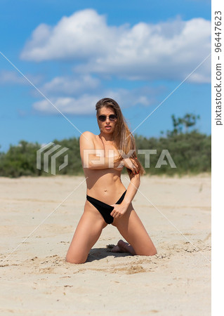 Sexual woman in bikini panties on beach Sexual woman in bikini panties on beach 96447623