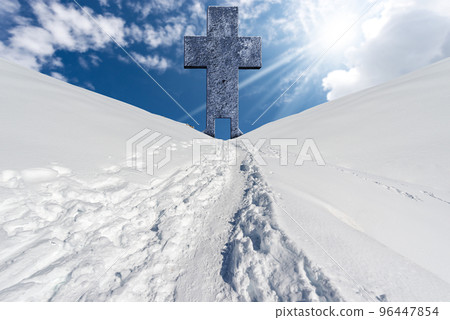 Large Stone Religious cross and Trail with Footprints in the Snow Large Stone Religious cross and Trail with Footprints in the Snow 96447854