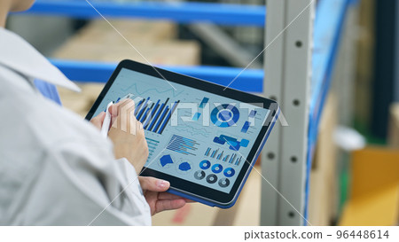 Workers looking at data on a tablet 96448614