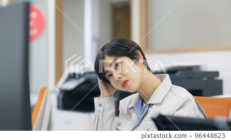 Engineer holding his head in the office 96448623