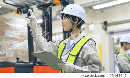 Employees inspecting the factory 96448642