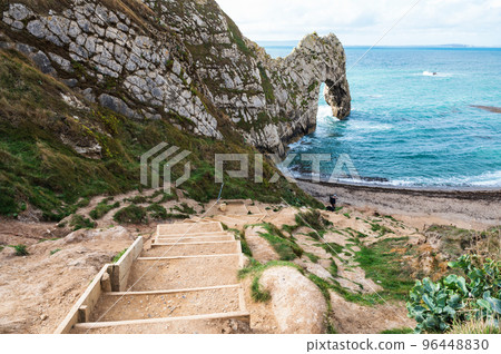Views of natural rock formations Durdle door in Lulworth, Dorset, United Kingdom. Part of Jurassic Coast World Heritage Site, view of stone arch and blue sea, selective focus Views of natural rock formations Durdle door in Lulworth, Dorset, United Kingdom. Part of Jurassic Coast World Heritage Site, view of stone arch and blue sea, selective focus 96448830
