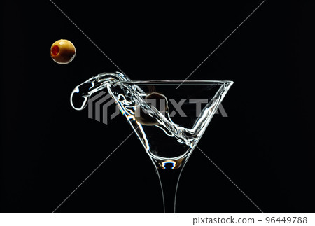 Silhouette of martini with green olives on a black background. 96449788