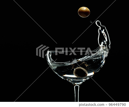 Silhouette of martini with green olives on a black background. 96449790